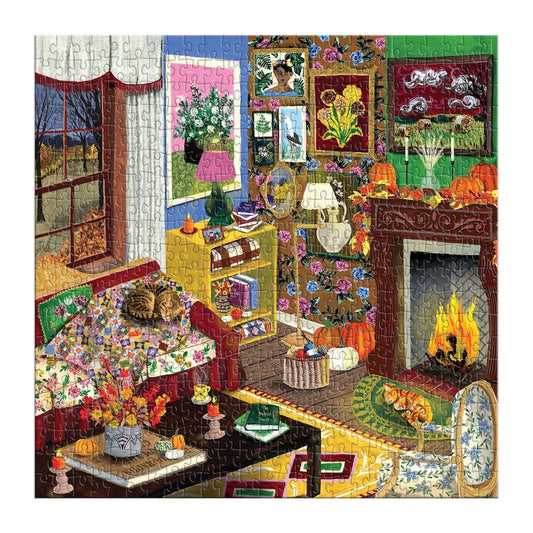 A completed jigsaw puzzle depicting a cozy, colorful autumn living room scene with a fireplace, cat on a couch, flowers, pumpkins, and framed art.