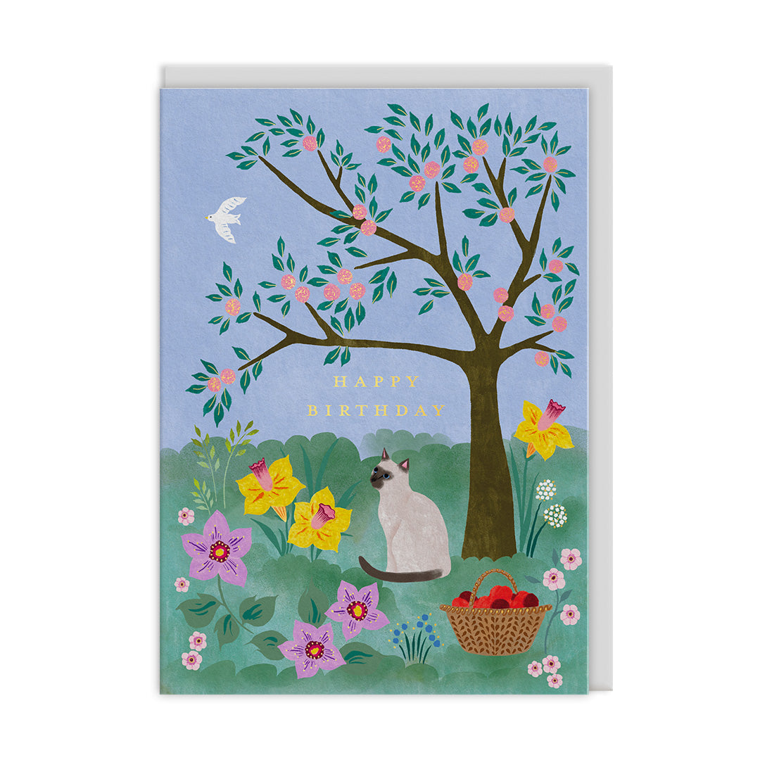 Birthday card with a cat, tree, and flowers on a blue background