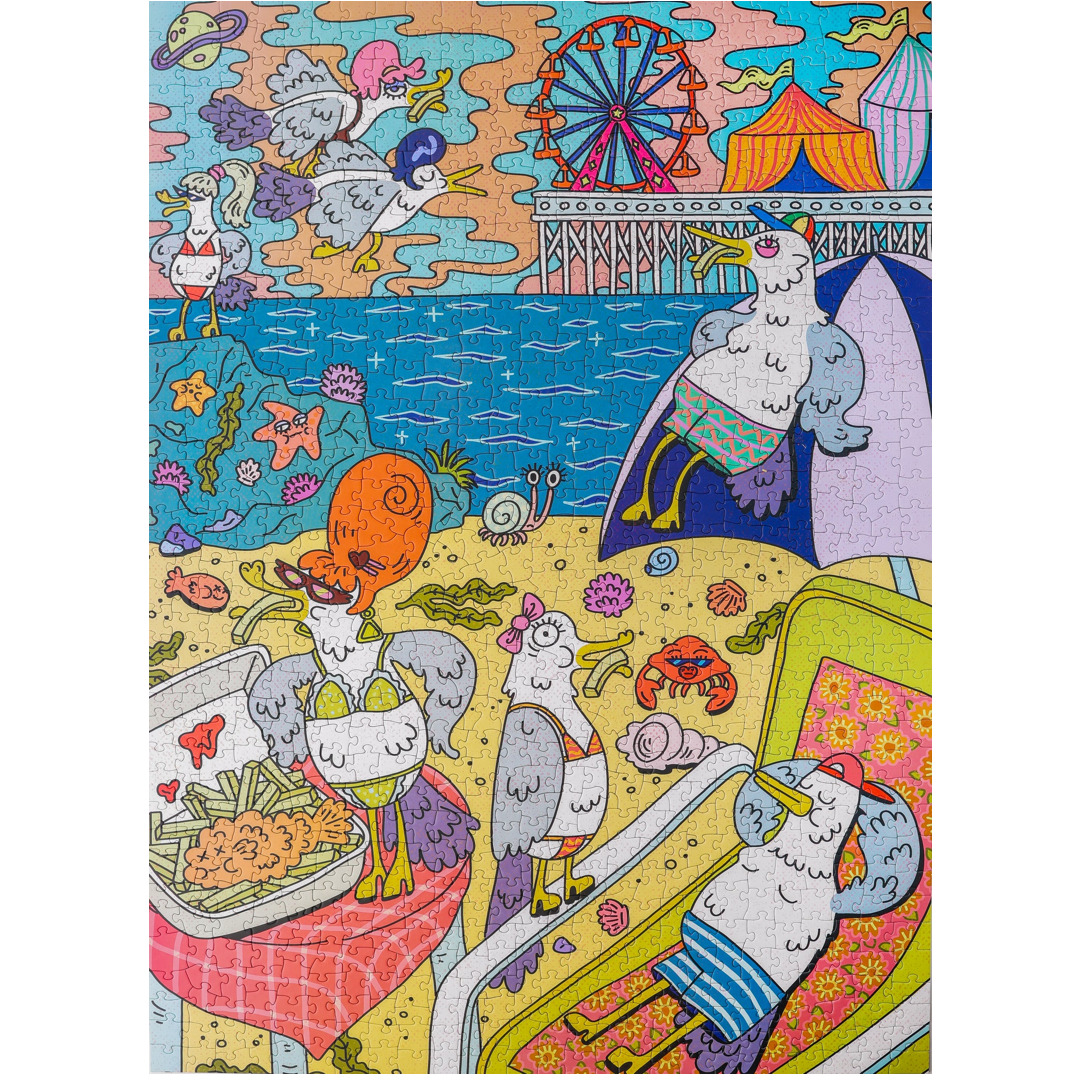 A colorful illustrated puzzle featuring whimsical seagull characters in an ocean fair scene with a Ferris wheel, beach, food stalls, and bright pastel and saturated colors.