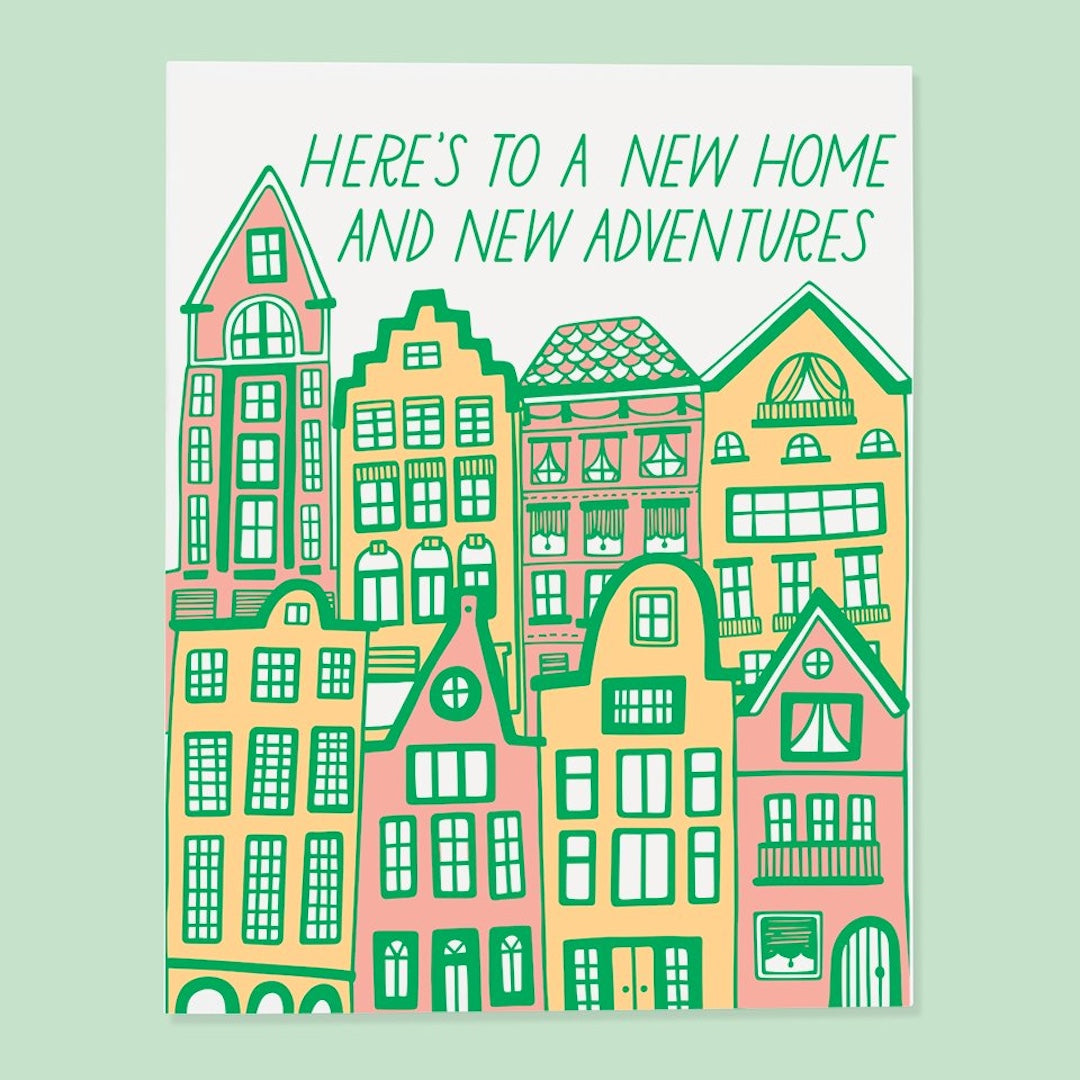 Illustration of colorful houses with text 'Here's to a new home and new adventures' on a light green background