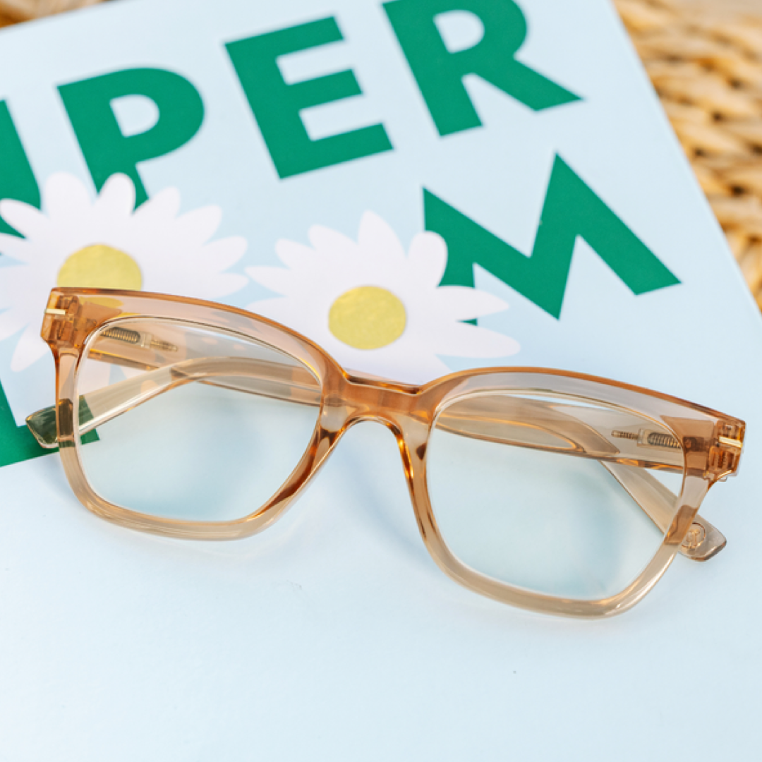 light brown glasses on a magazine with flowers