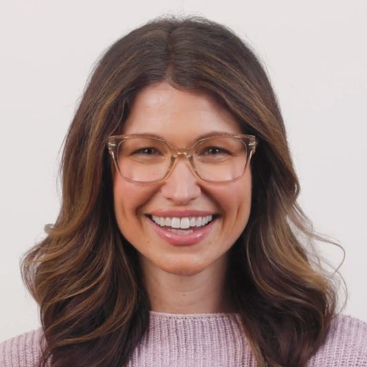 Woman wearing glasses with a plain background