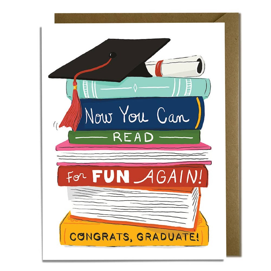 Graduation-themed card with books and a cap with text that reads 'now you can read for fun again. Congrats, graduate!' on a white background