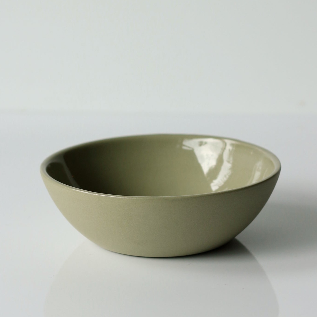 Sage green ceramic bowl on a white background