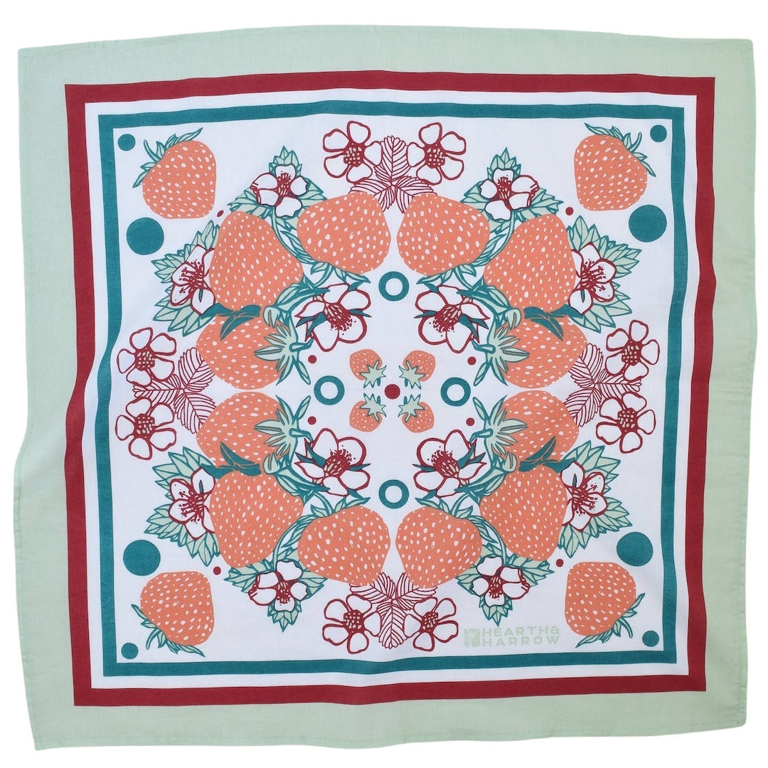 Square bandana with strawberry pattern on a light green background