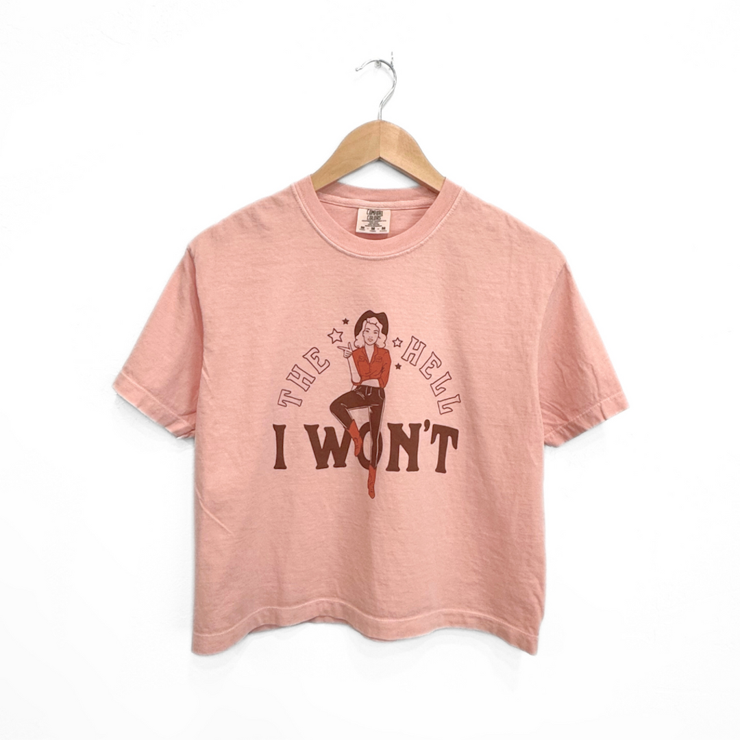 pink cropped t shirt with a cowgirl on it along with text that reads the hell I won't