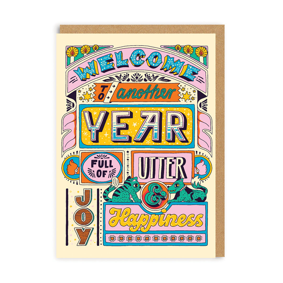 Colorful greeting card with decorative text and graphics on a white background. Text reads welcome to another year full of utter joy and happiness.