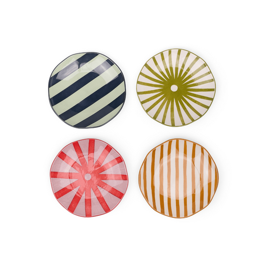 Set of four round ceramic plates with striped patterns on a white background