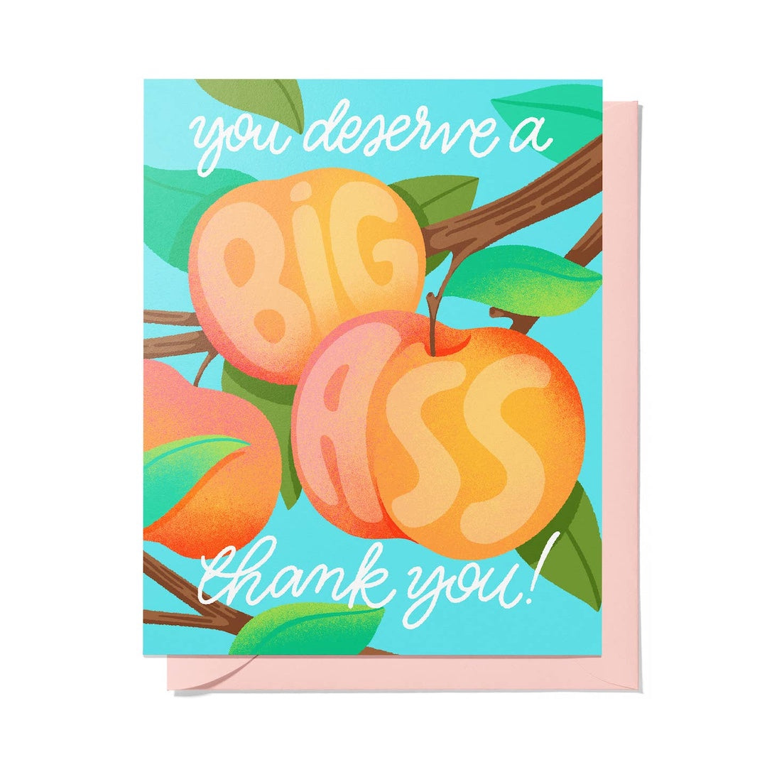 A square greeting card with a pink envelope, featuring an illustration of three peaches on a branch with green leaves against a light blue background. White script text reads 'you deserve a BIG ASS thank you!'.