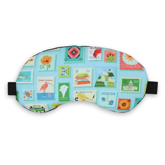 Colorful sleep mask with postage stamp design on a white background