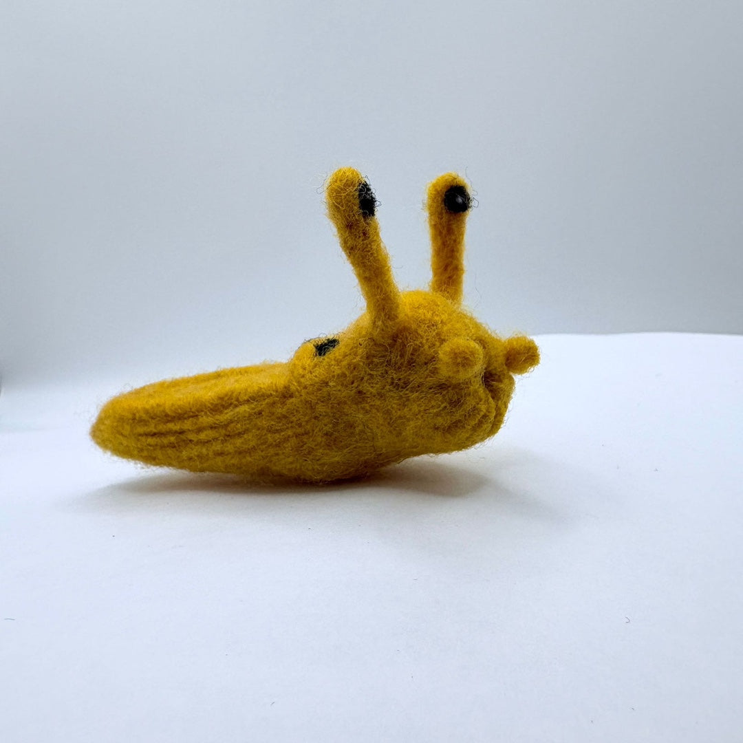 felt banana slug on a white background