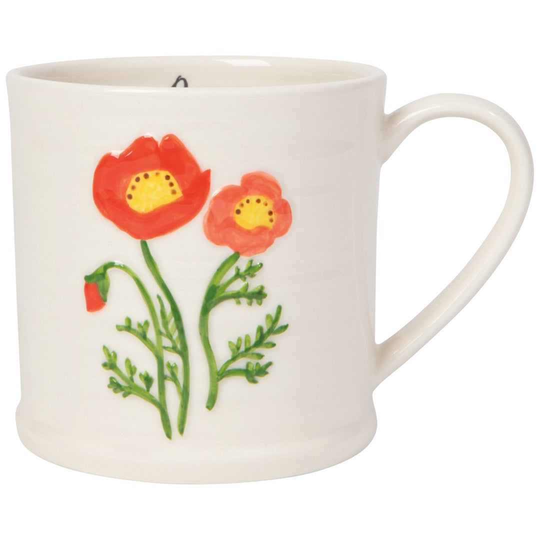 White mug with red poppy design on a white background