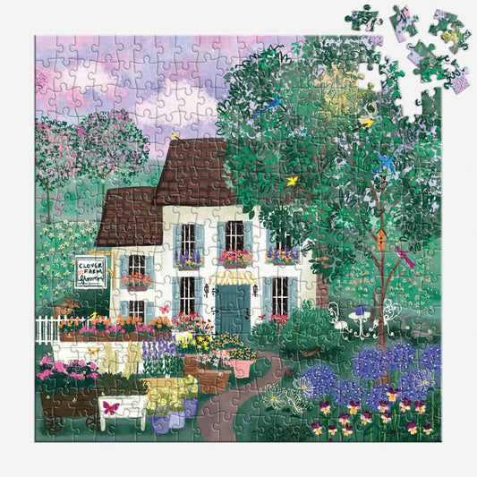 Jigsaw puzzle with a completed scene of a house and garden