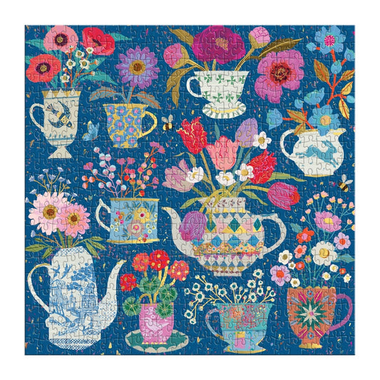 Jigsaw puzzle with floral and teapot design on a blue background