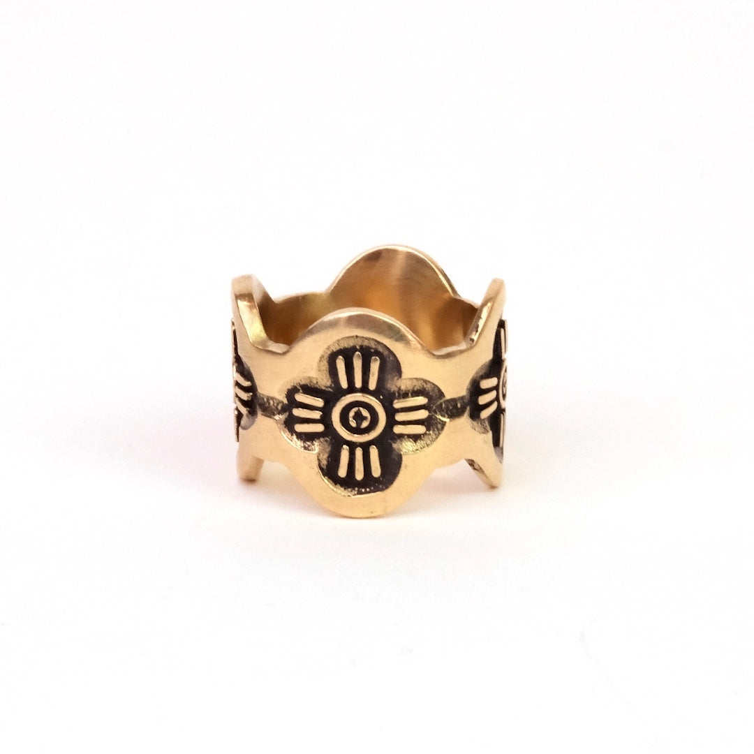 Brass ring with floral design on a white background