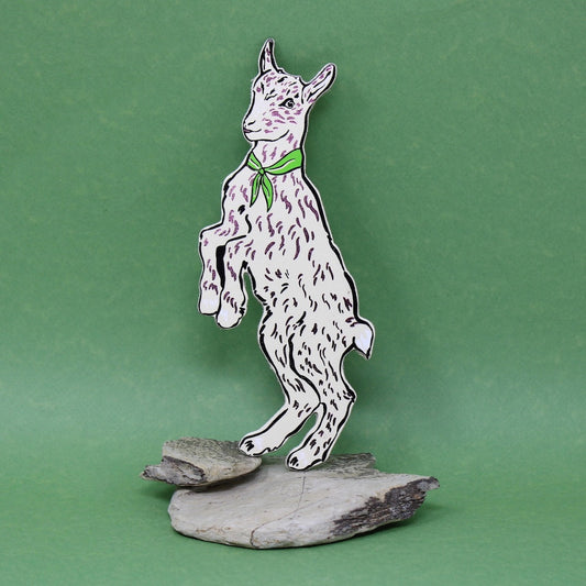 Cream goat shaped leather bookmark on a green background