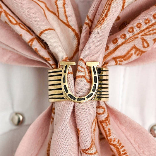 Brass horseshoe bandana slide on a light pink bandana