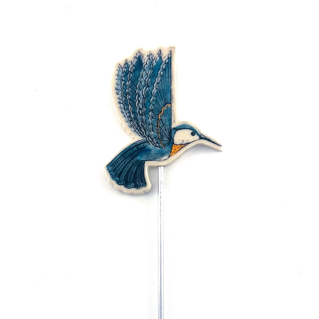 Decorative garden stake with a blue hummingbird design on a white background