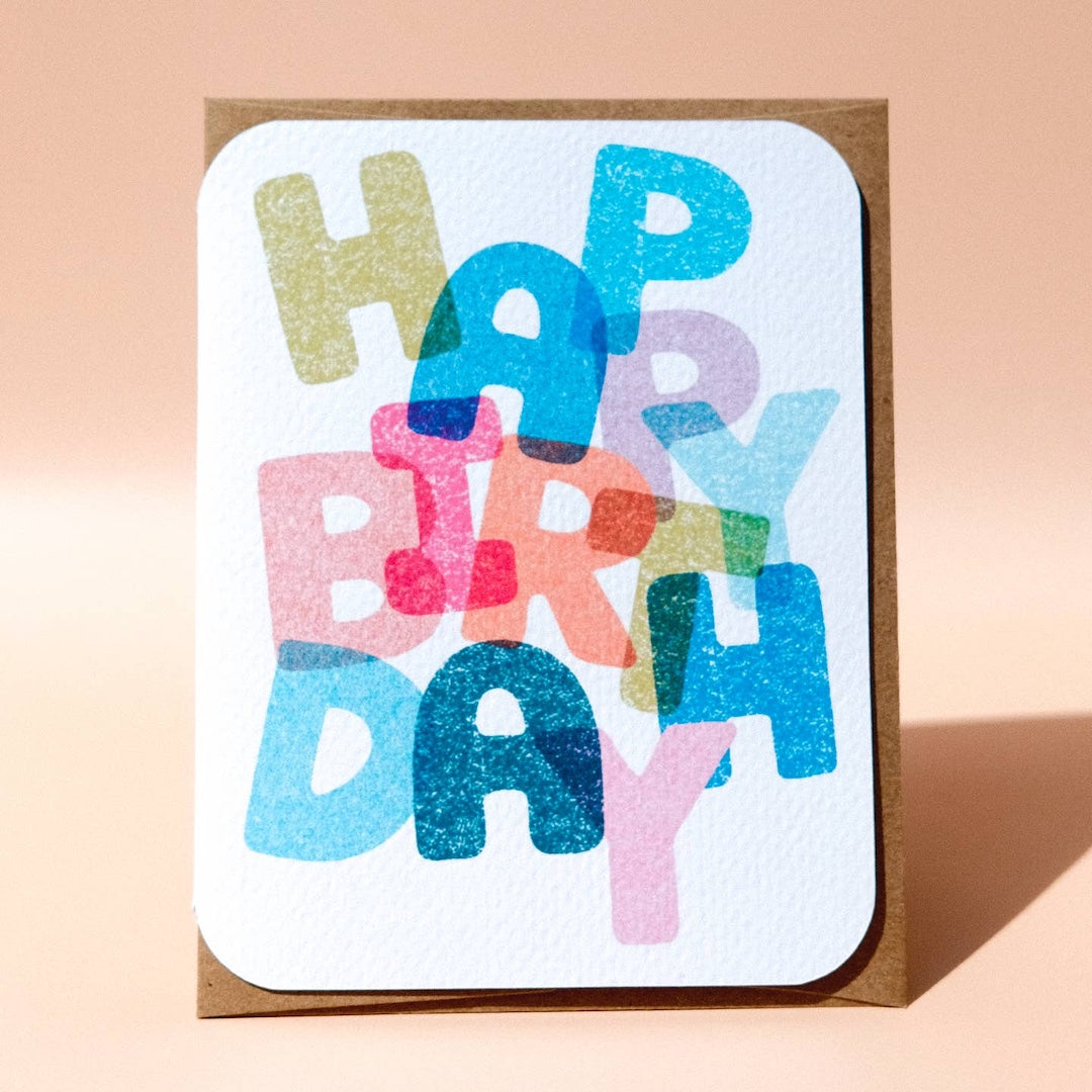 Colorful 'Happy Birthday' card on a beige background