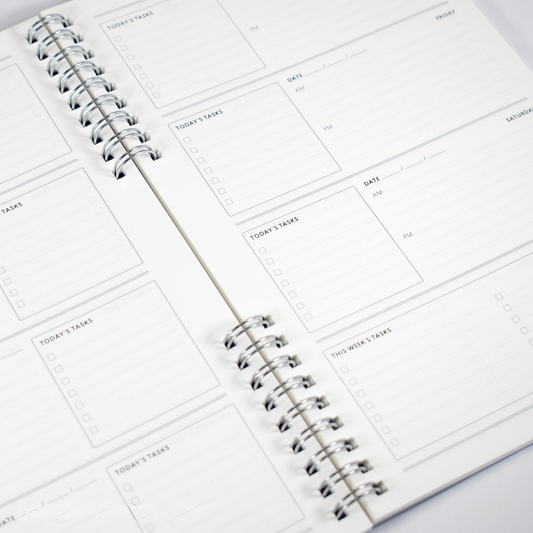 Spiral-bound planner with daily task layout on white background