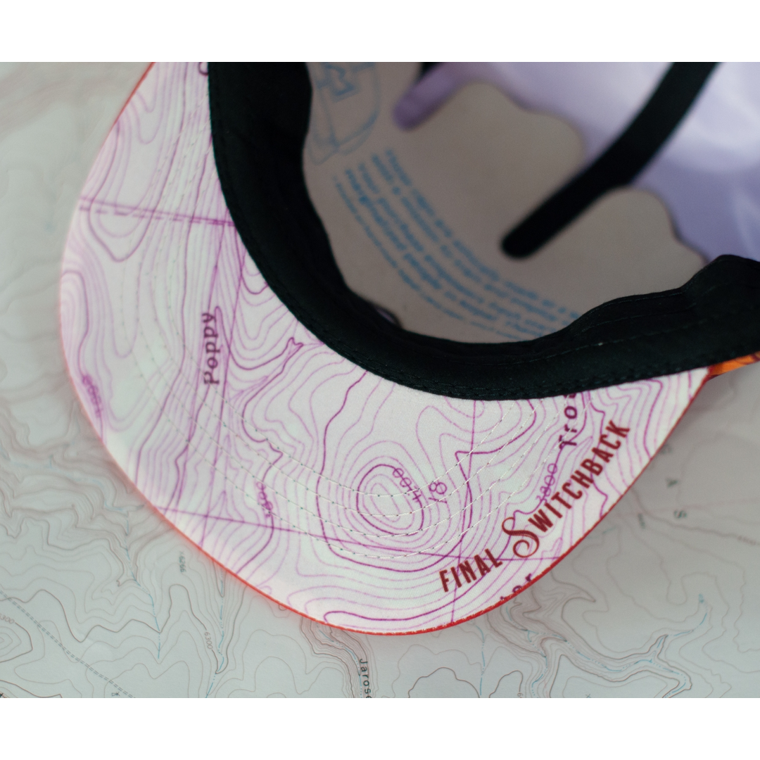 Close up of the underside of a cap's visor that features a topographical map and Final Switchback branding