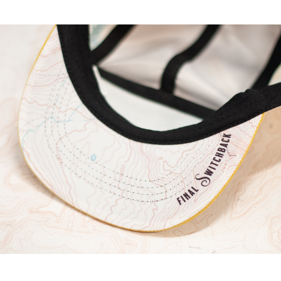 Under side of the cap visor with a topographical map pattern and Final Switchback branding