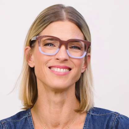 Woman wearing glasses with a plain background