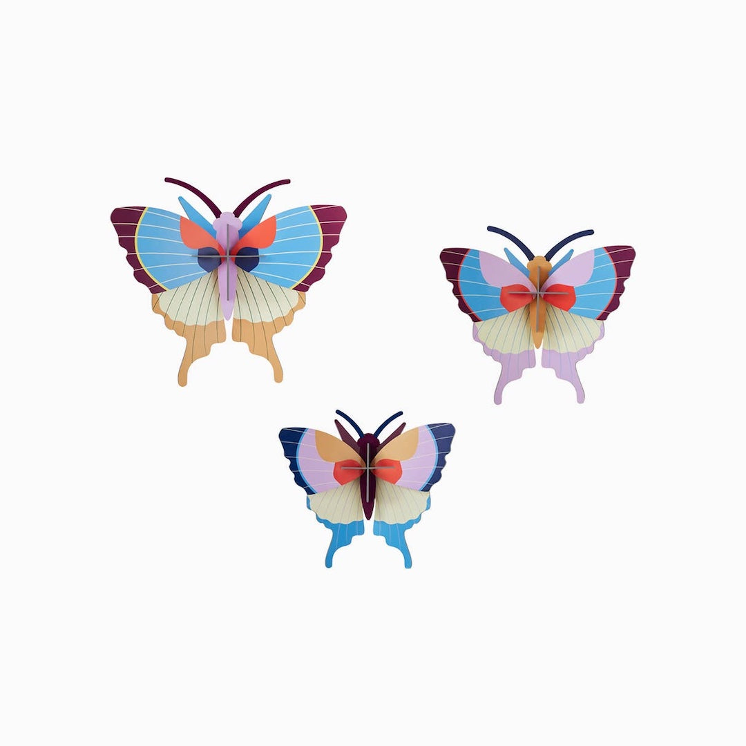 Three colorful butterfly decorations on a white background