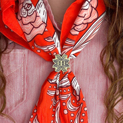Red patterned scarf with a brass bandana slide