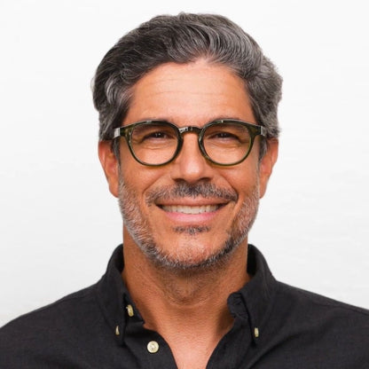 Man wearing glasses and a black shirt on a white background