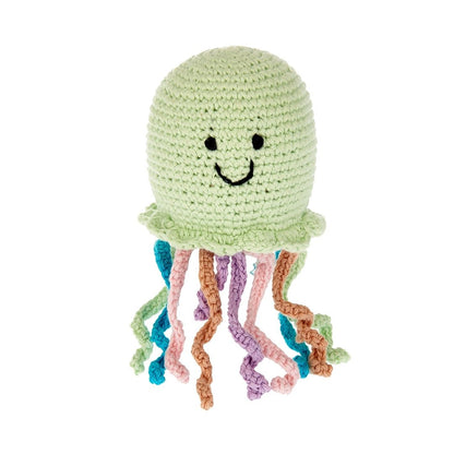 Crocheted jellyfish toy with a smiling face on a white background