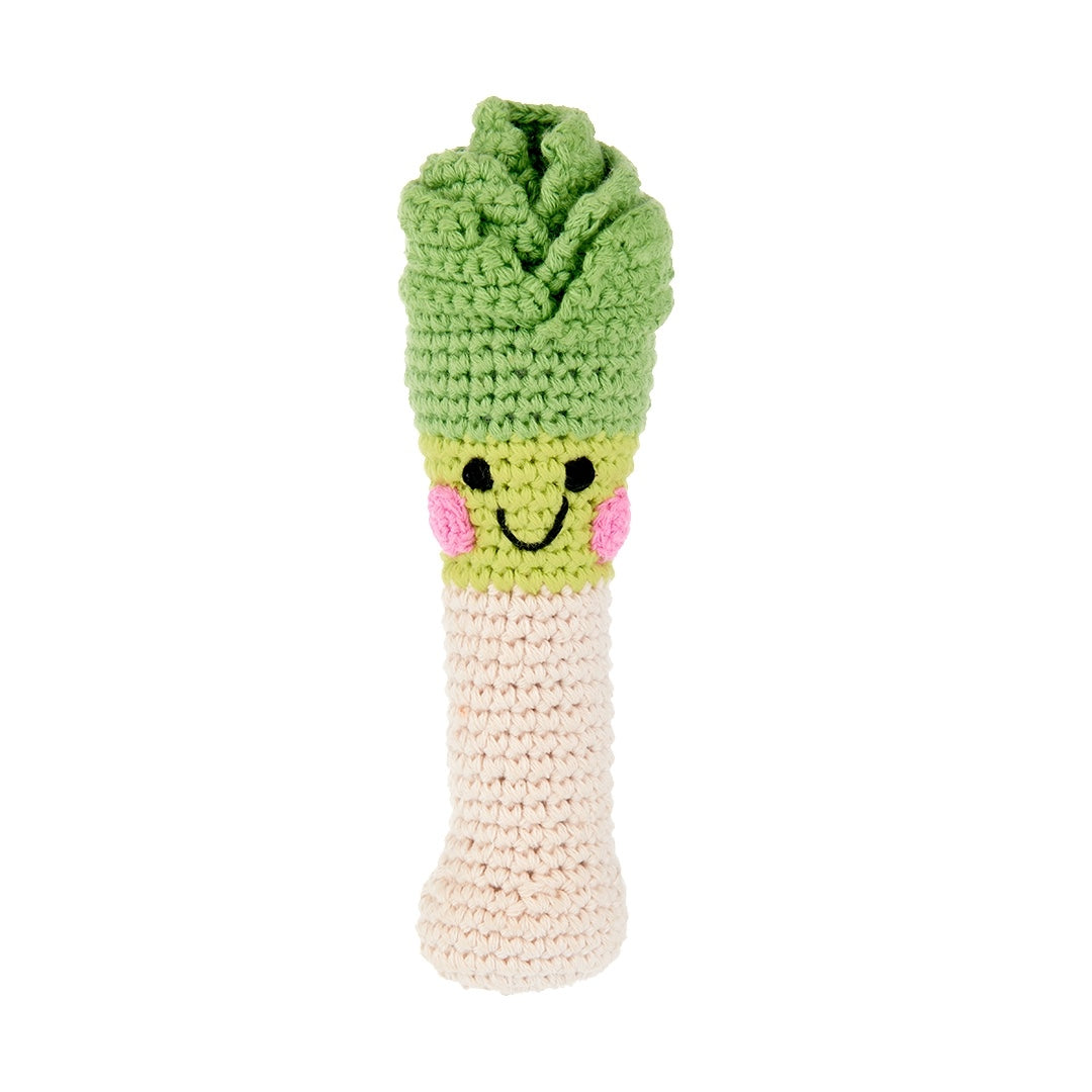 Crocheted leek rattle with a smiley face on a white background