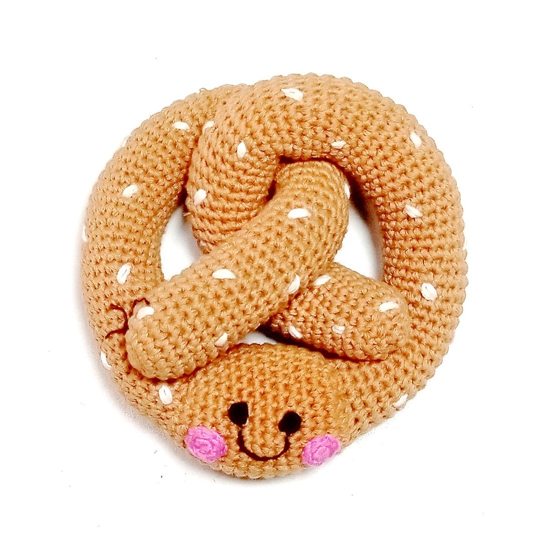 Crocheted pretzel rattle on a white background