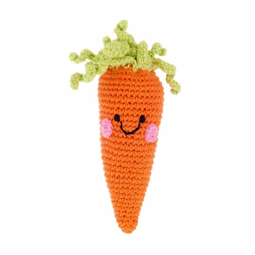 Crocheted carrot toy with a smiling face on a white background