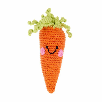 Crocheted carrot toy with a smiling face on a white background