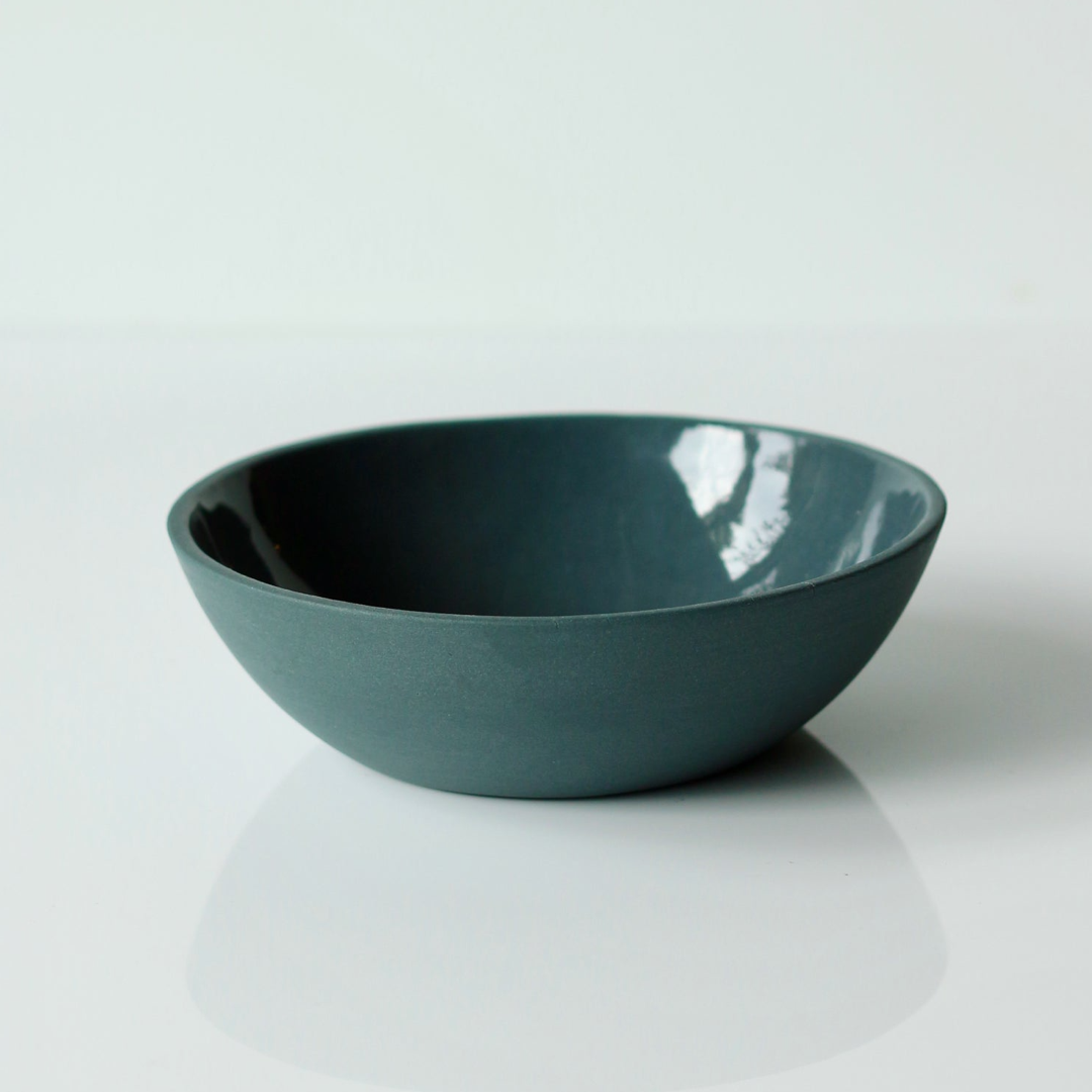 Dark demin blue ceramic bowl on a white background