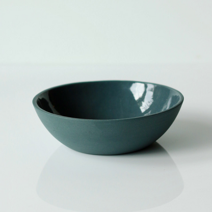 Dark demin blue ceramic bowl on a white background