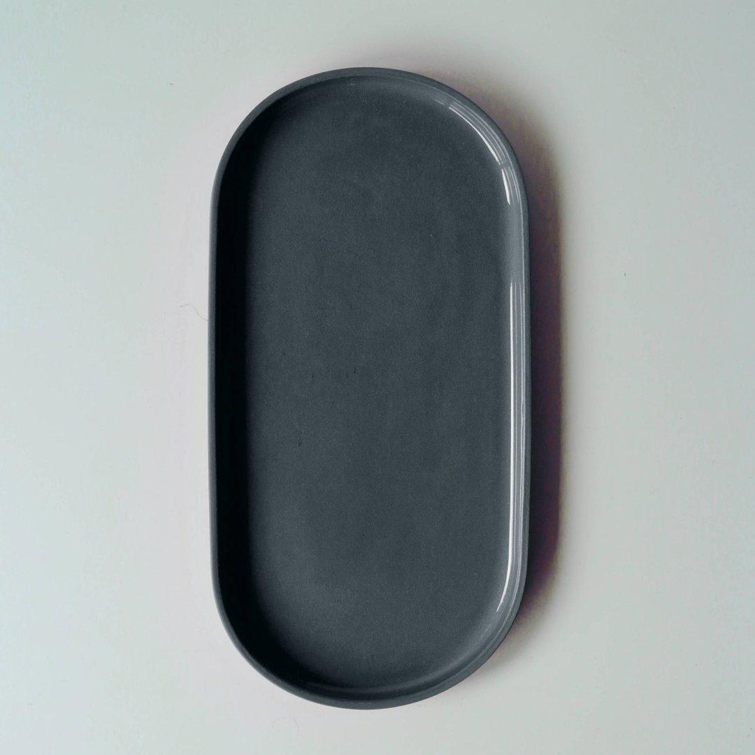 Dark denim blue oval tray on a light gray background