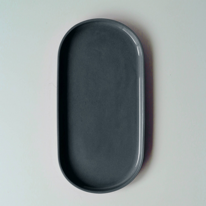 Dark denim blue oval tray on a light gray background