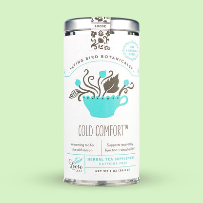 Tea canister labeled 'Cold Comfort' by Flying Bird Botanicals on a light green background