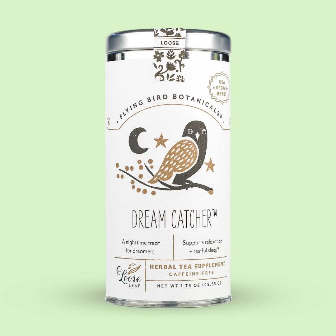 Tea canister labeled 'Dream Catcher' by Flying Bird Botanicals on a light green background