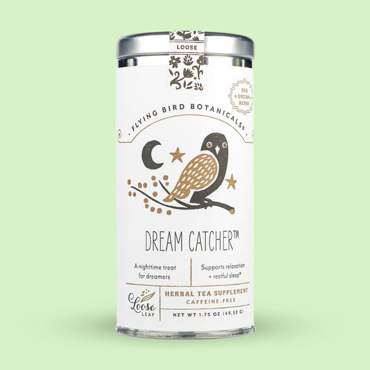 Tea canister labeled 'Dream Catcher' by Flying Bird Botanicals on a light green background