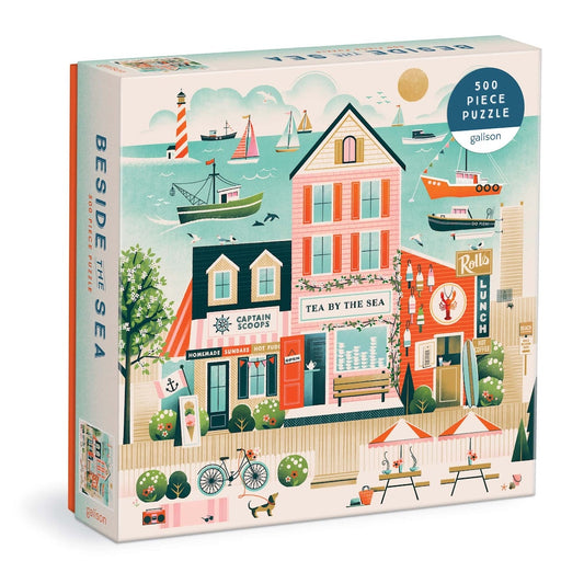 Jigsaw puzzle box with a coastal scene design featuring buildings and boats.