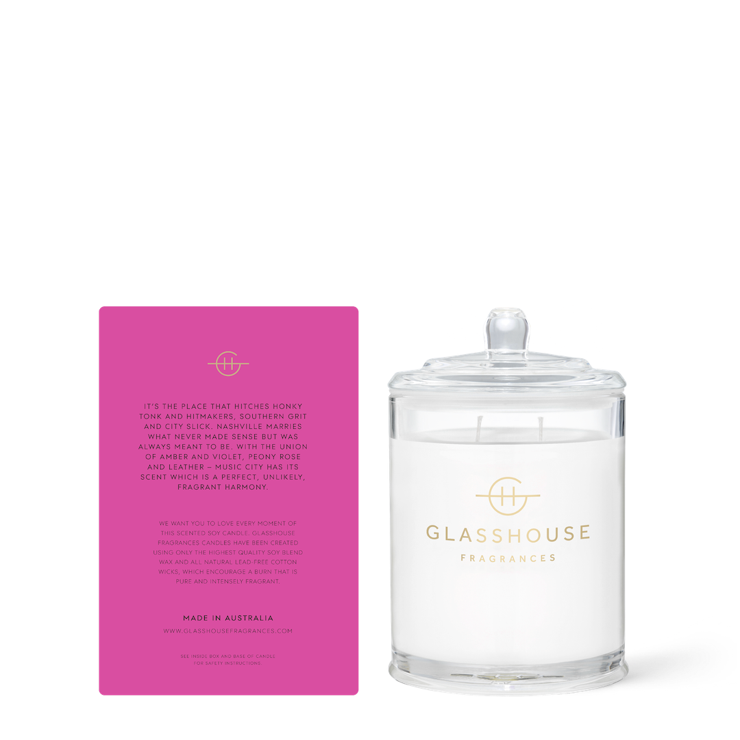 Glasshouse Fragrances candle with its pink box on a white background