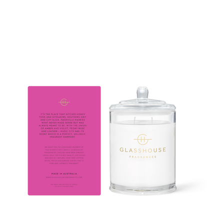 Glasshouse Fragrances candle with its pink box on a white background
