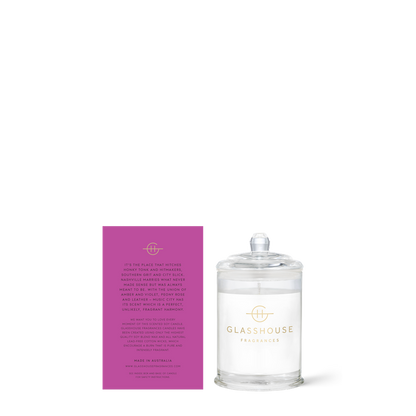 Glasshouse candle with its purple box on a white background