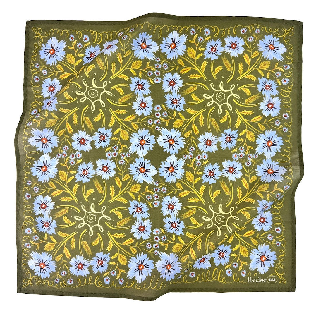 Floral patterned bandana with blue flowers and green leaves on a white background