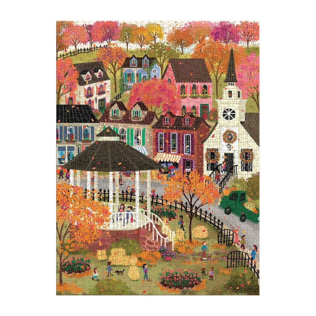 Jigsaw puzzle featuring a colorful illustration of a fall village scene with houses, a church, and a gazebo in an autumn setting.