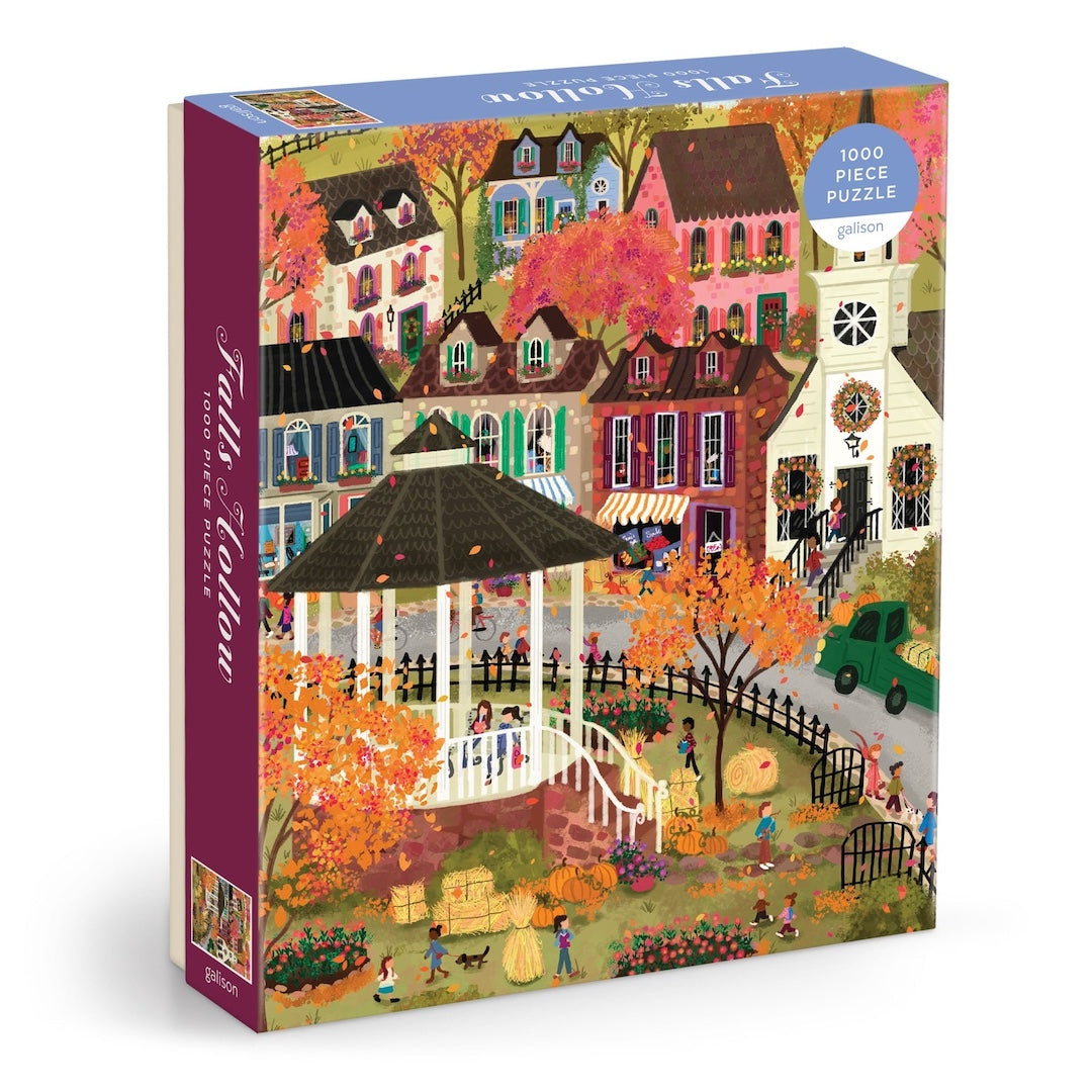 Jigsaw puzzle box with a colorful fall village scene on a white background