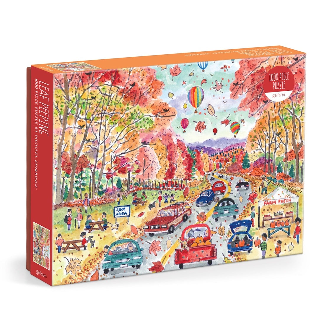 Colorful puzzle box with an autumn-themed design featuring trees, people, and cars.